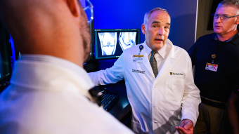 James Stannard standing in front of a computer screen.