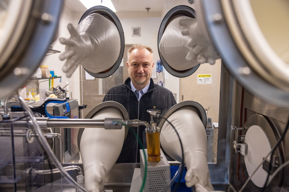 Anthony Griffiths posing with equipment in his lab.