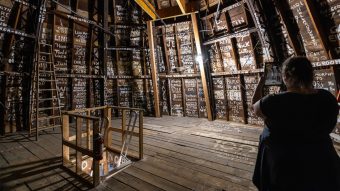 a woman scans the names covering the inside walls of Jesse Hall's dome.