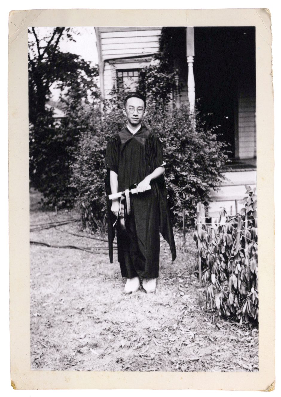 George Kao standing outdoors in his graduation gown