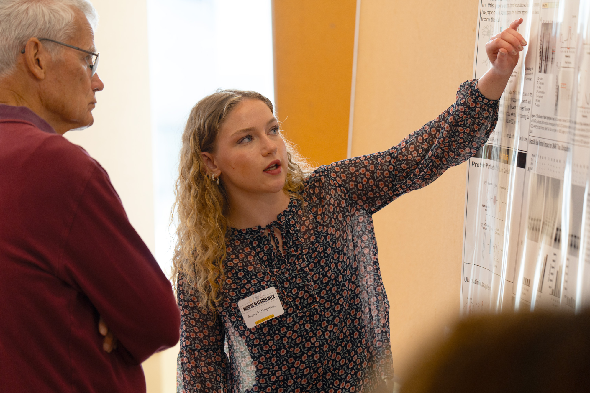 Student points to poster