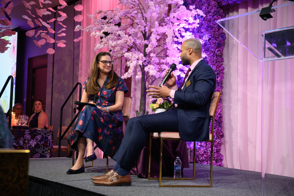 Two people on stage talking