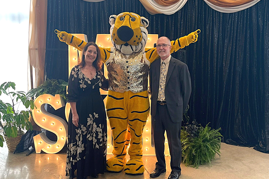 Two people with Truman the Tiger
