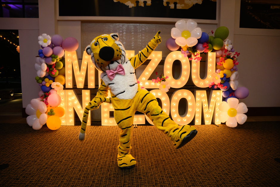 Truman the Tiger in front of Mizzou in Bloom sign