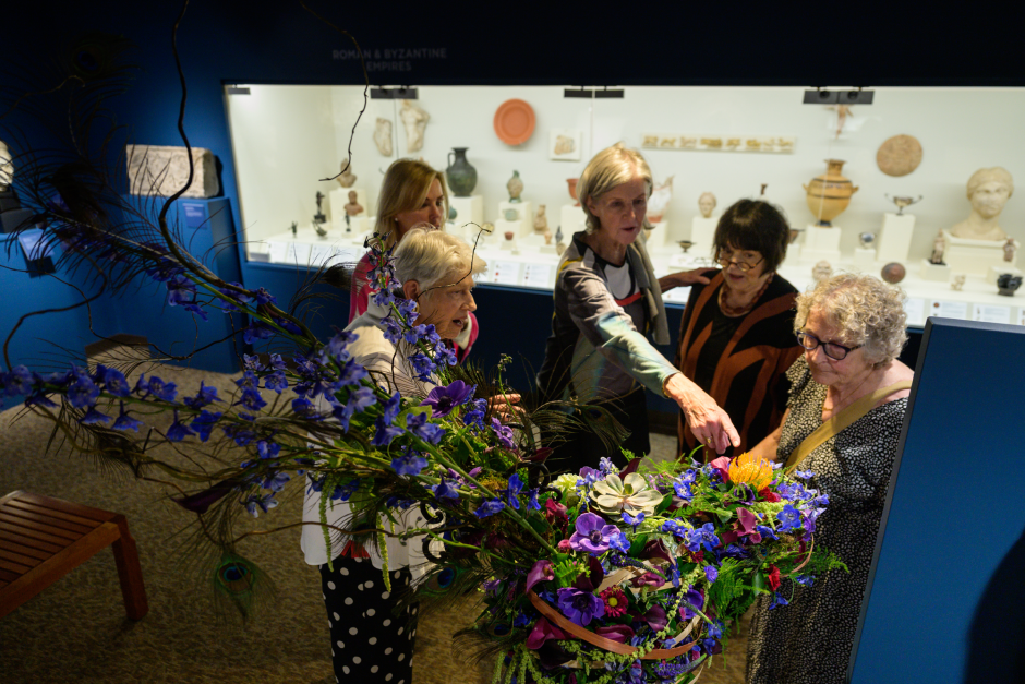 Attendees look at floral exhibits