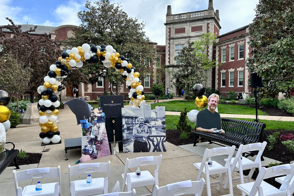 Cutouts of alumni at front of outdoor ceremony