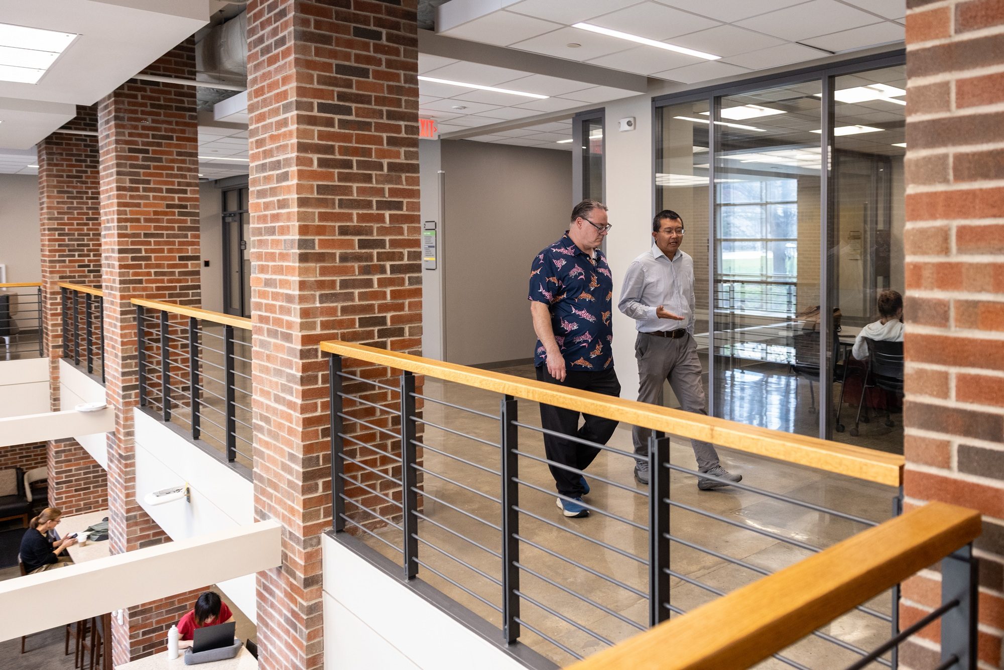 two researchers walking down a hallway in the college of engineering