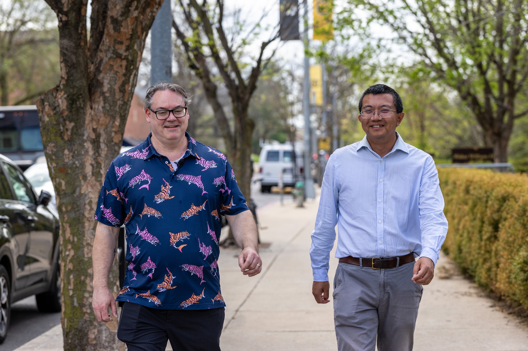 two researchers walking down ninth street in downtown columbia