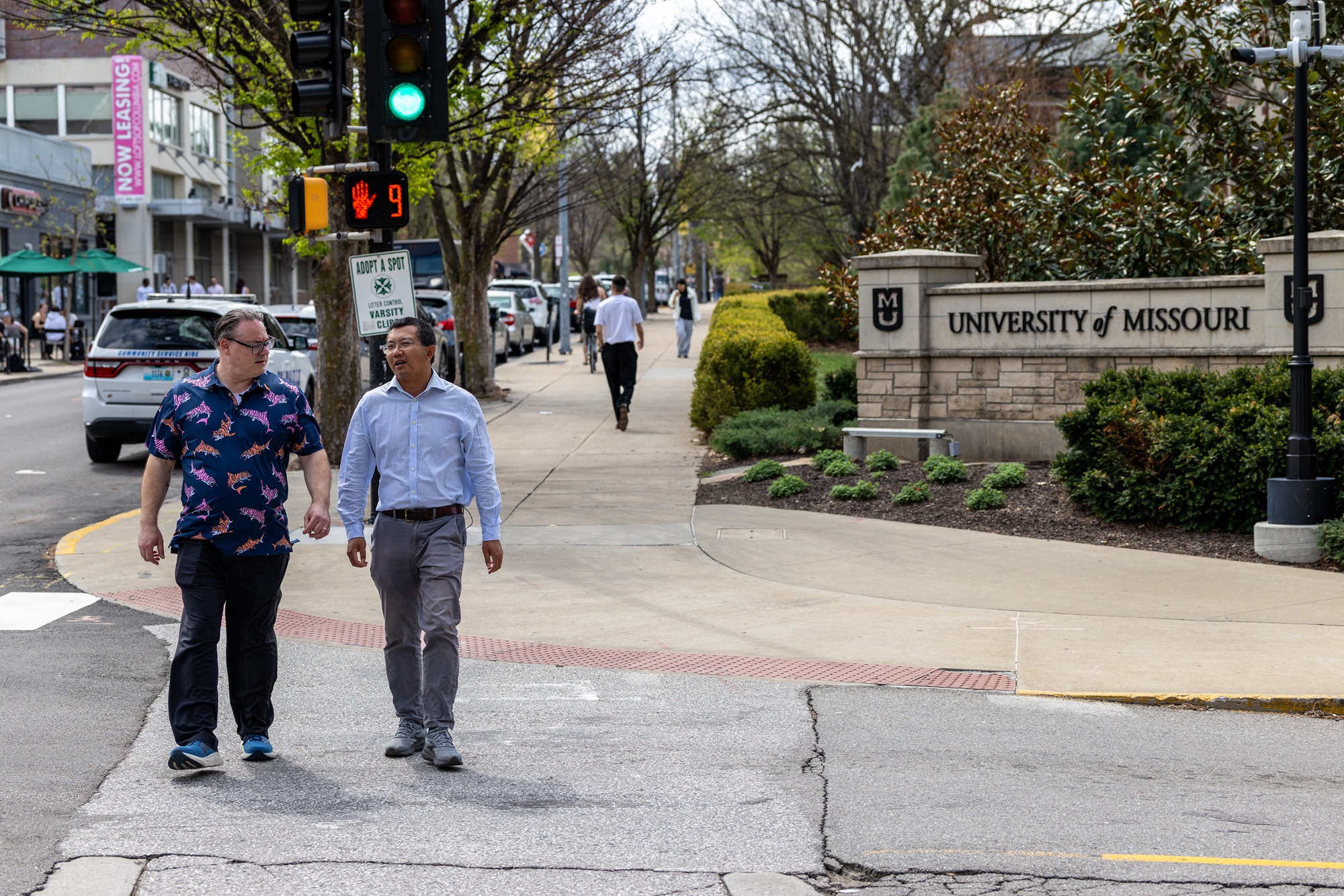 two researchers crossing a street in downtown columbia
