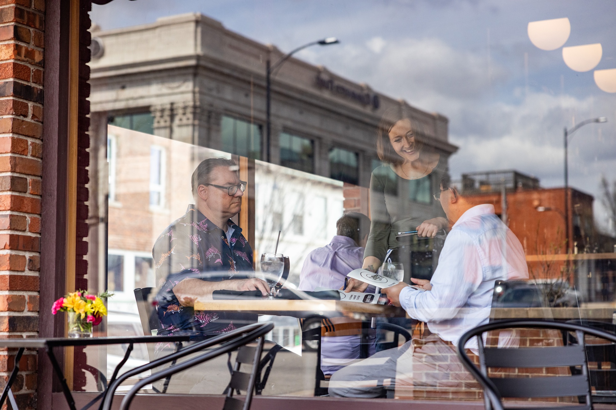 two researchers speak with a waitress at a downtown Columbia restaurant