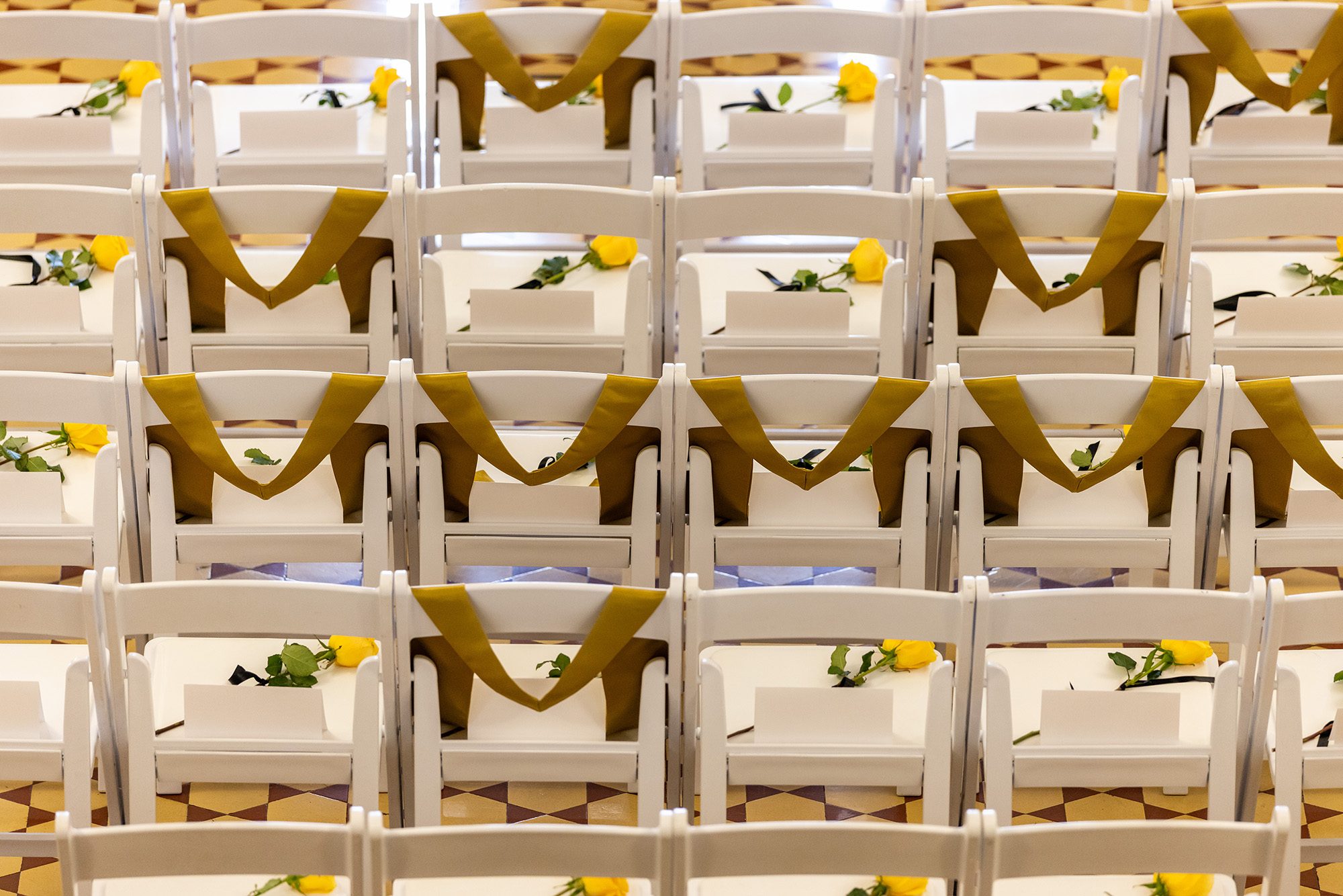 20260410_OP_MU-Remembers-004 Yellow roses on the seats of white chairs