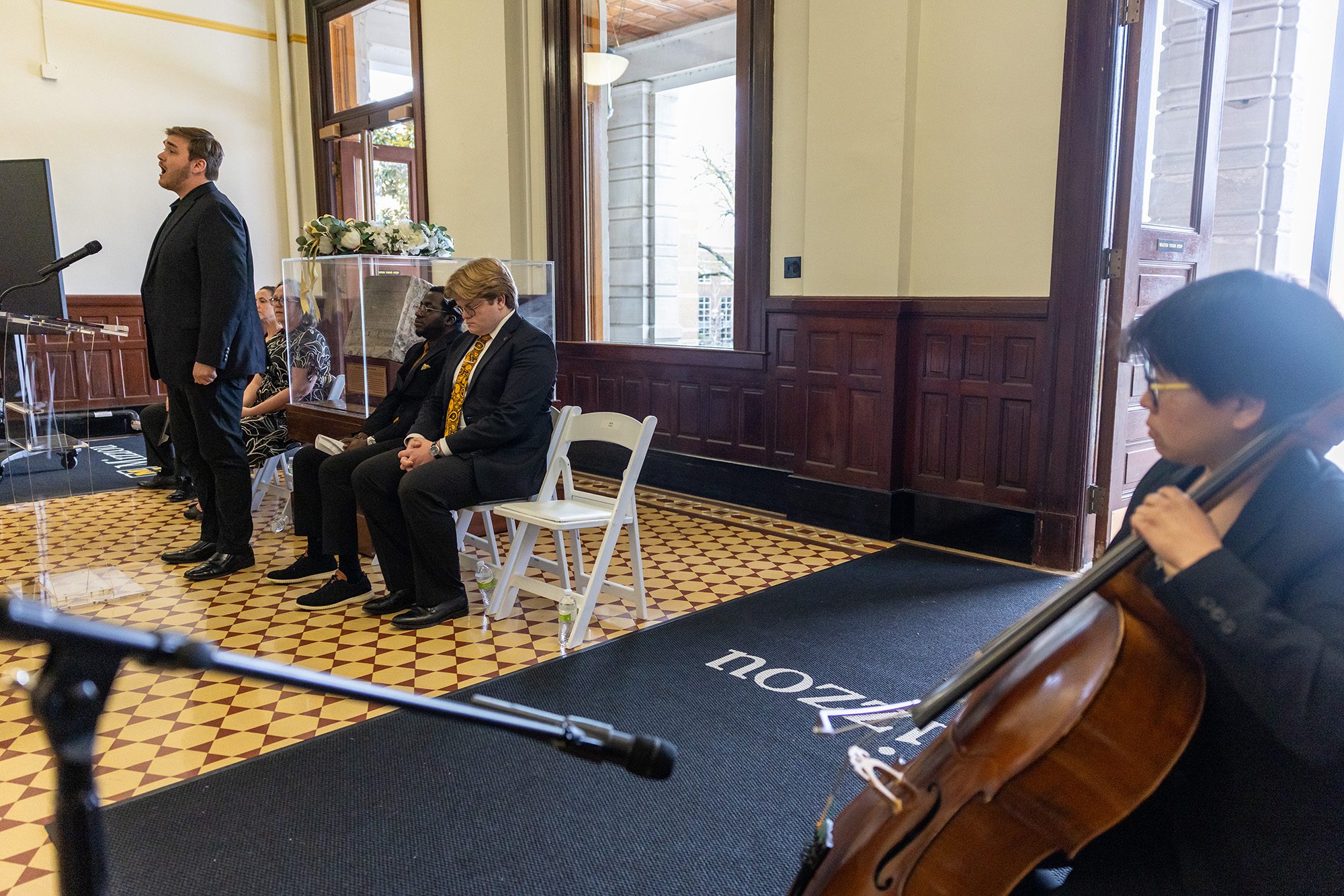 20260410_OP_MU-Remembers-017 Person singing while musician plays