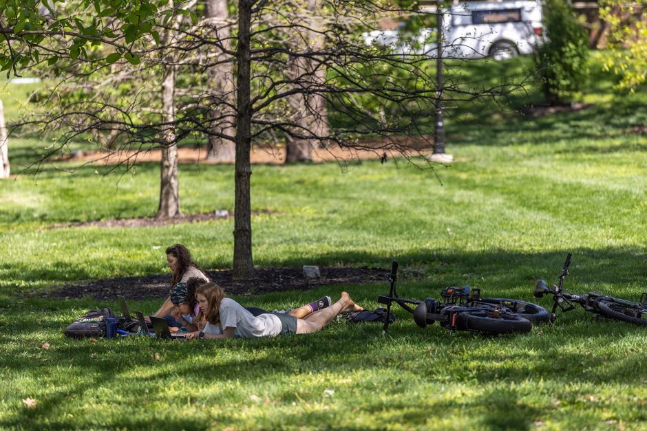 Two students lying on the grass in Peace Park