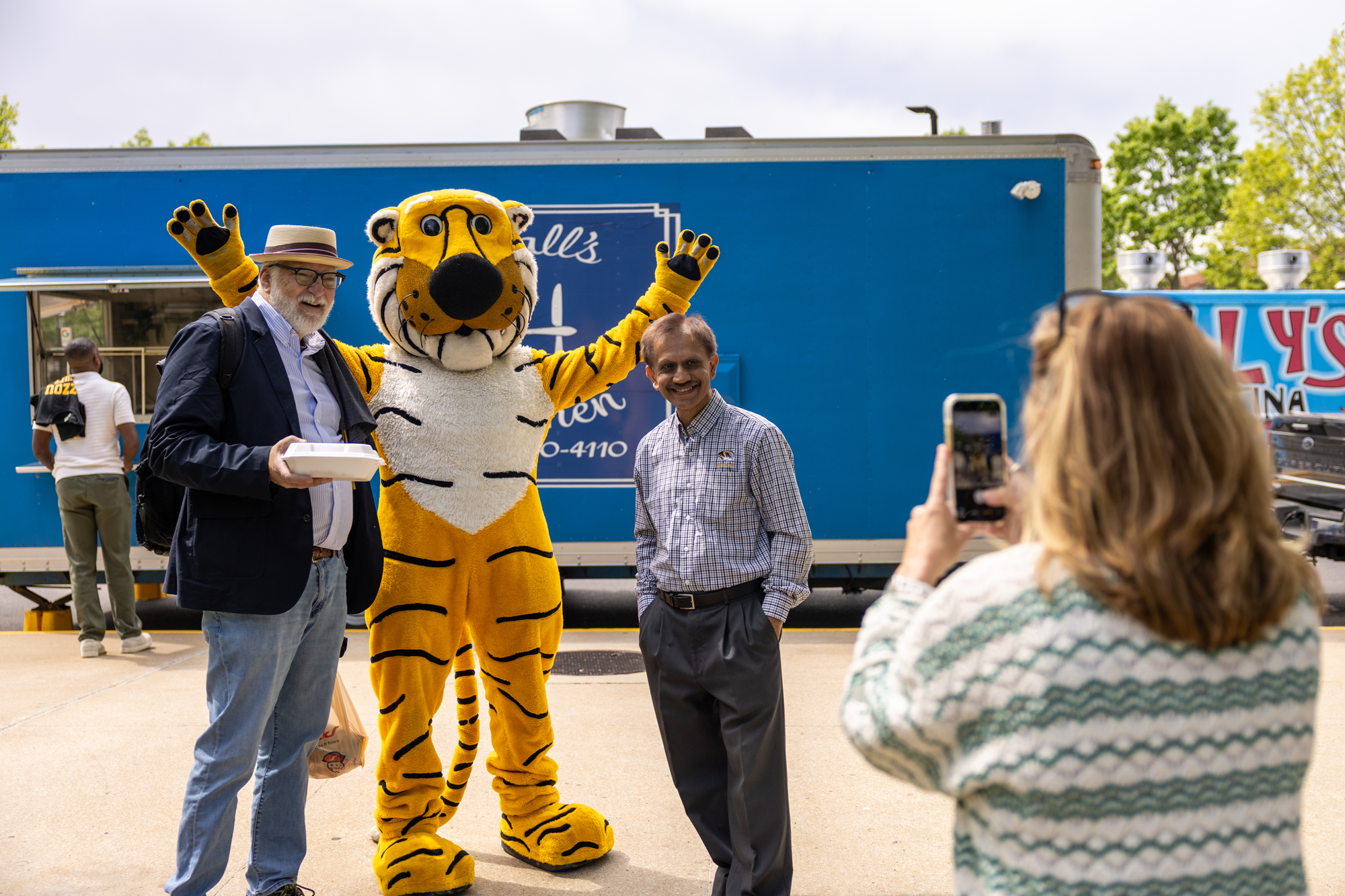 Faculty members pose with Truman the Tiger