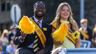 Mathew Kimaku riding in a car during the Homecoming Parade.
