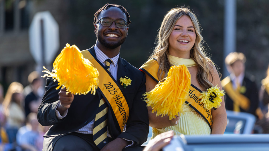 Mathew Kimaku riding in a car during the Homecoming Parade.