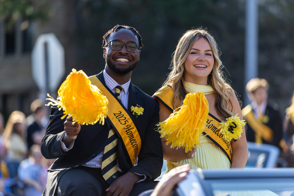 Mathew Kimaku riding in a car during the Homecoming Parade.
