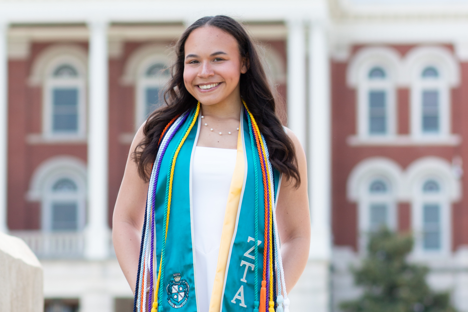 Alex Sanderson wears commencement cords.