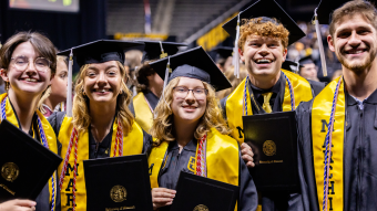 Graduates with diplomas