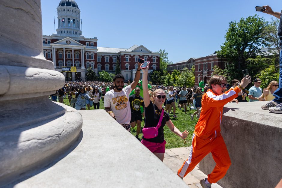 Students running through the Columns