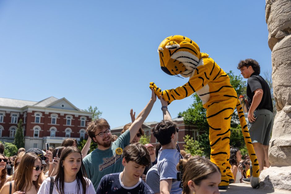 Truman the Tiger high-fiving students