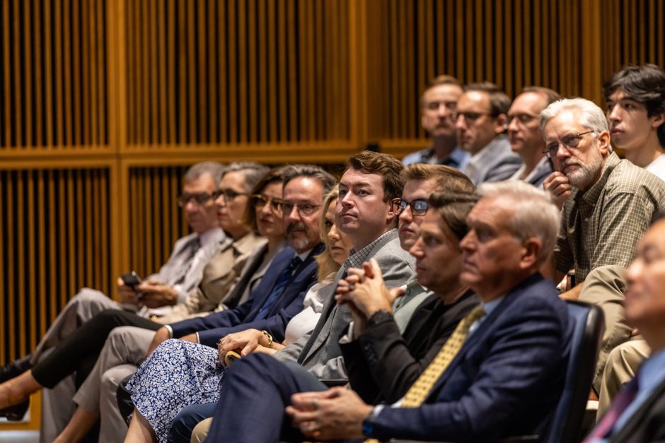 A group of people sitting in the audience at a lecture