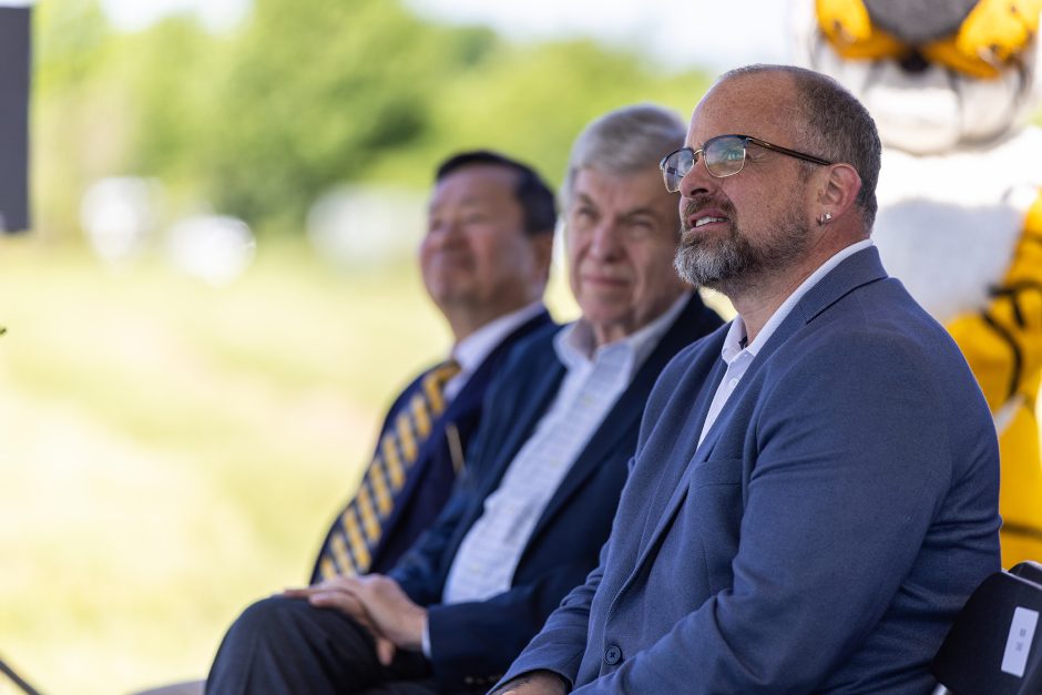 Three men sitting in a row