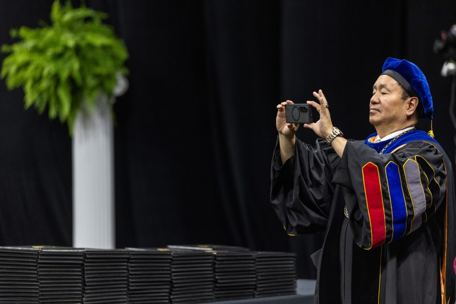 University of Missouri President Mun Choi taking a photo with phone