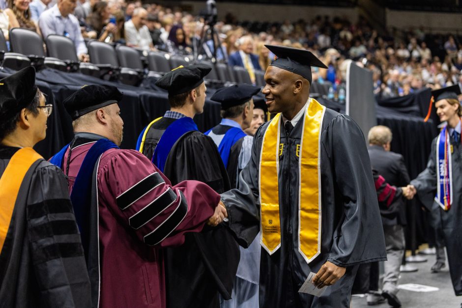 Graduate shaking hands with a faculty member