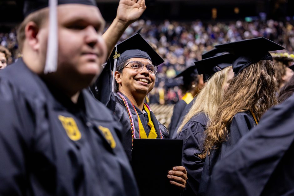 Graduate waving to the audience