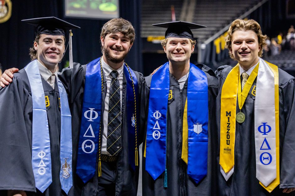 Four graduates posed