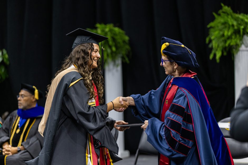 Graduate and faculty shaking hands