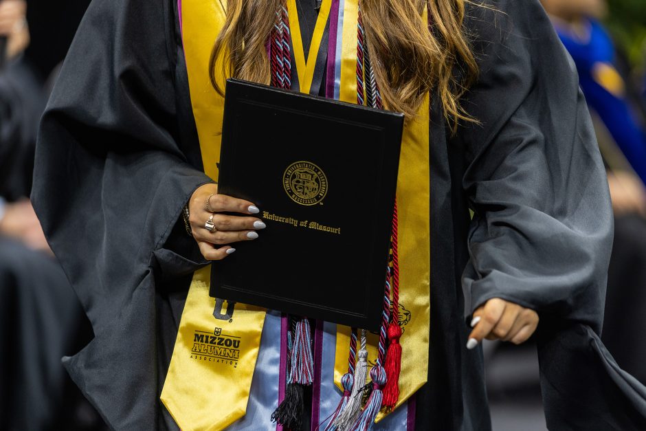 Graduate's hand holding a diploma