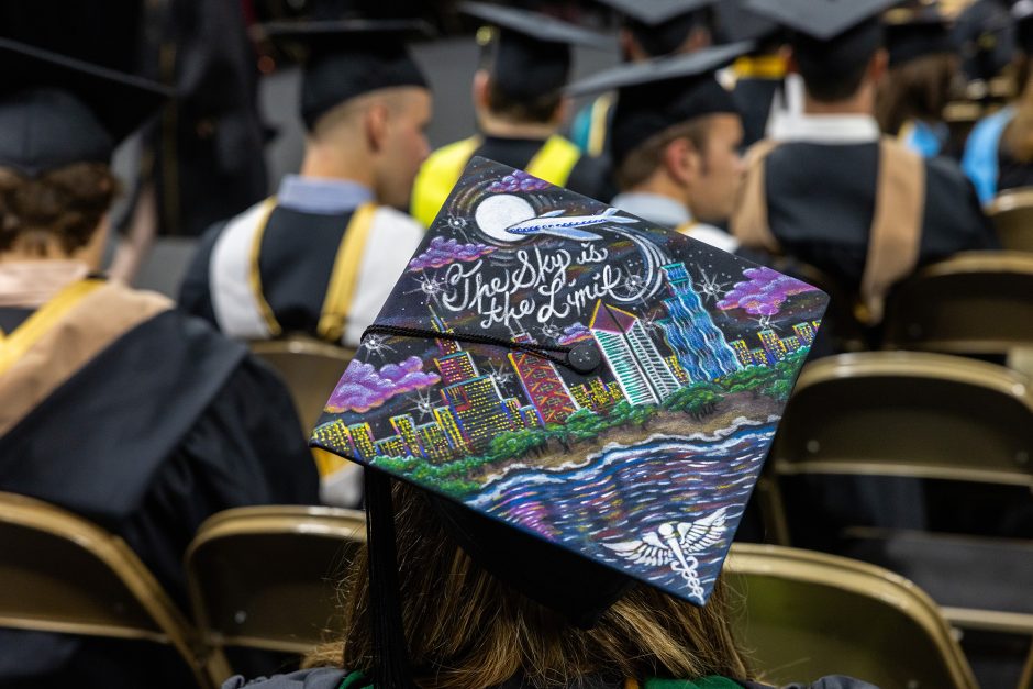 Decorated graduation cap that says "The sky is the limit"
