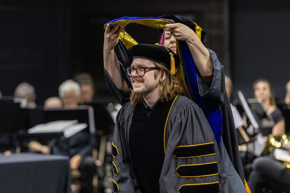 Graduate getting a hood placed on them