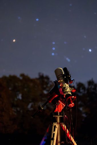 small telescope and camera system under a night sky