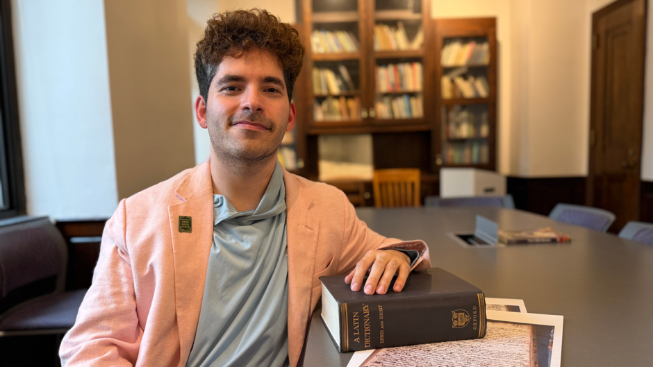 Jordi Alonso at table with book and manuscript pages