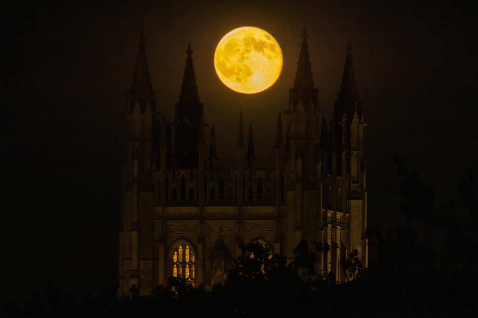 Harvest moon over building