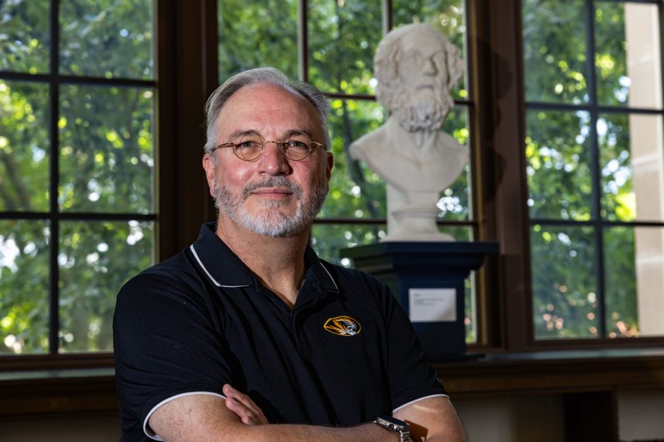 Professor Jim Crozier in front of bust of Homer