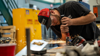 A member of the Tractor Pulling Team working in the shop.