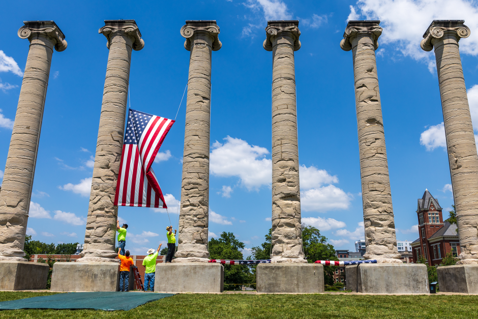 Crews remove flag banner from columns