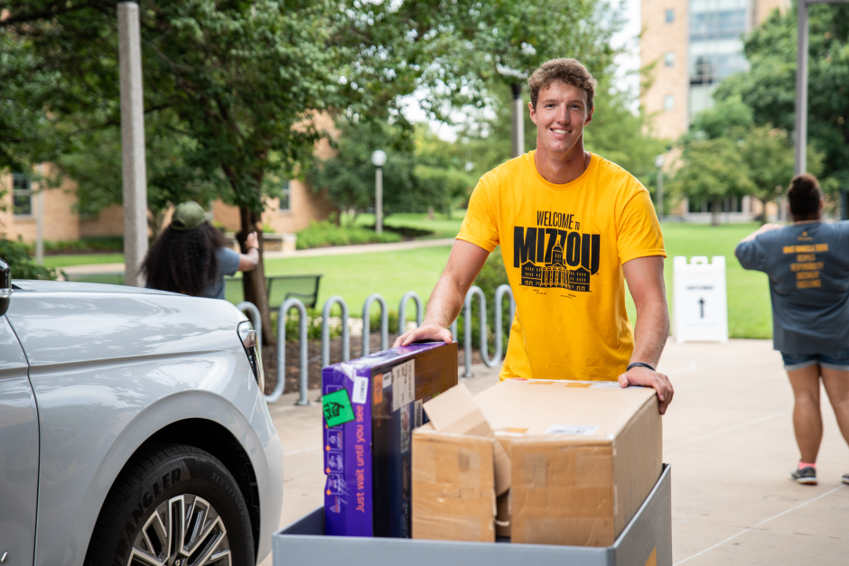 A volunteer moves boxes