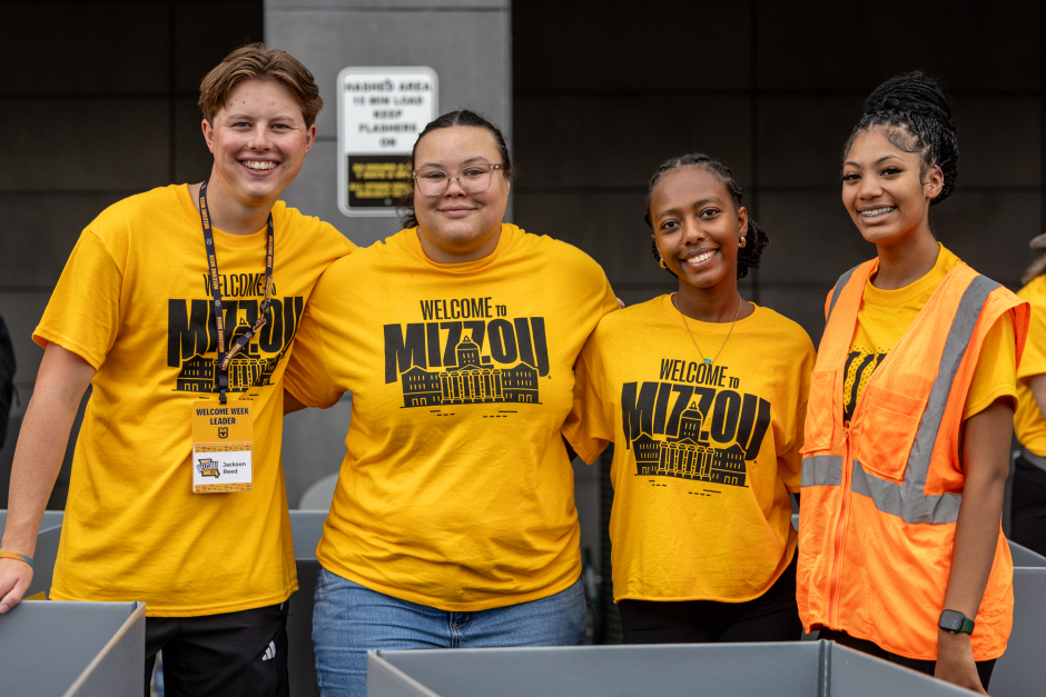 Volunteers in gold shirts