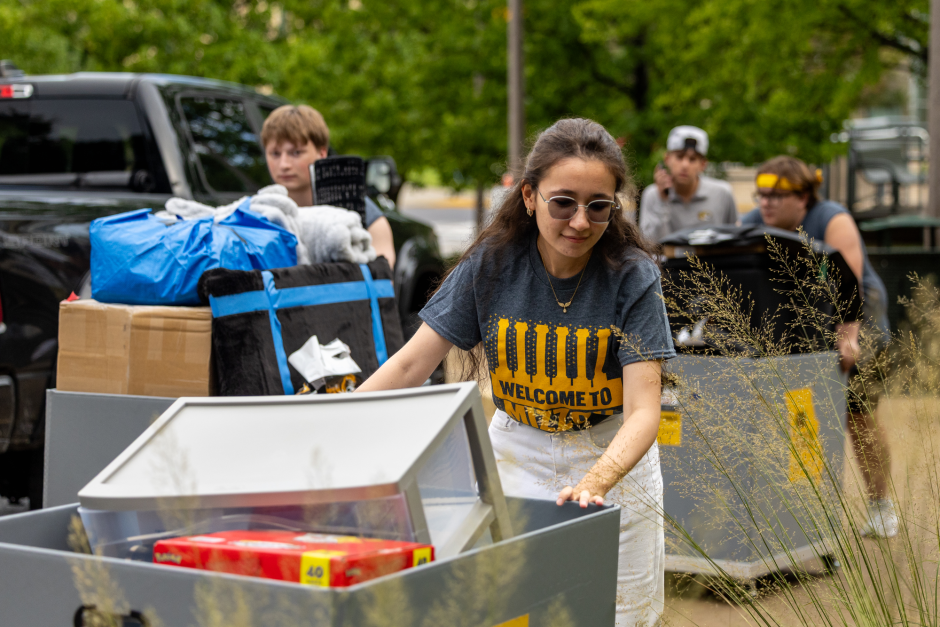 A volunteer moves boxes
