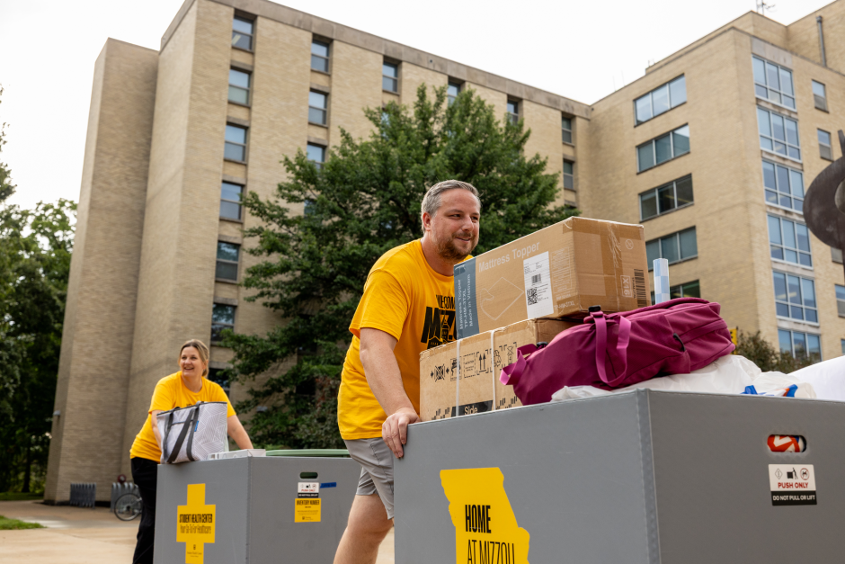 A volunteer moves boxes
