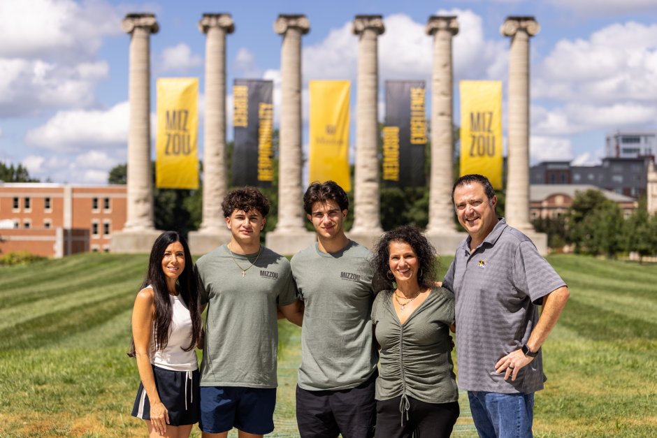 A family in front of the Columns