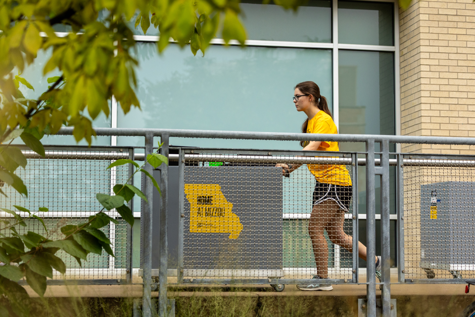 A volunteer rolls a bin