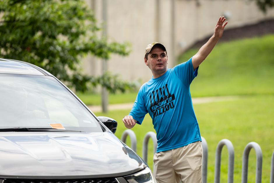 A volunteer directs traffic