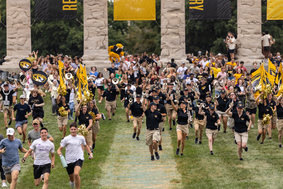 Students run through Columns