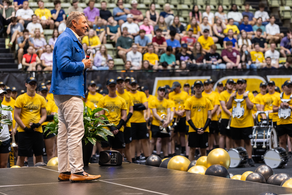 Man addresses crowd at academic convocation